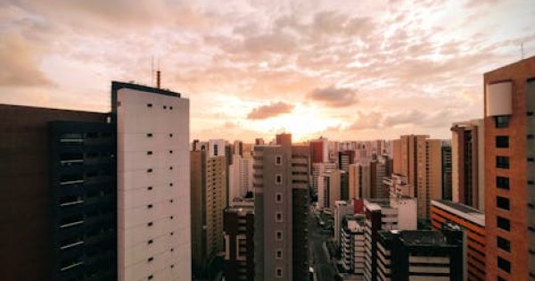 A stunning urban skyline view captured at sunset with a golden sky and modern skyscrapers.